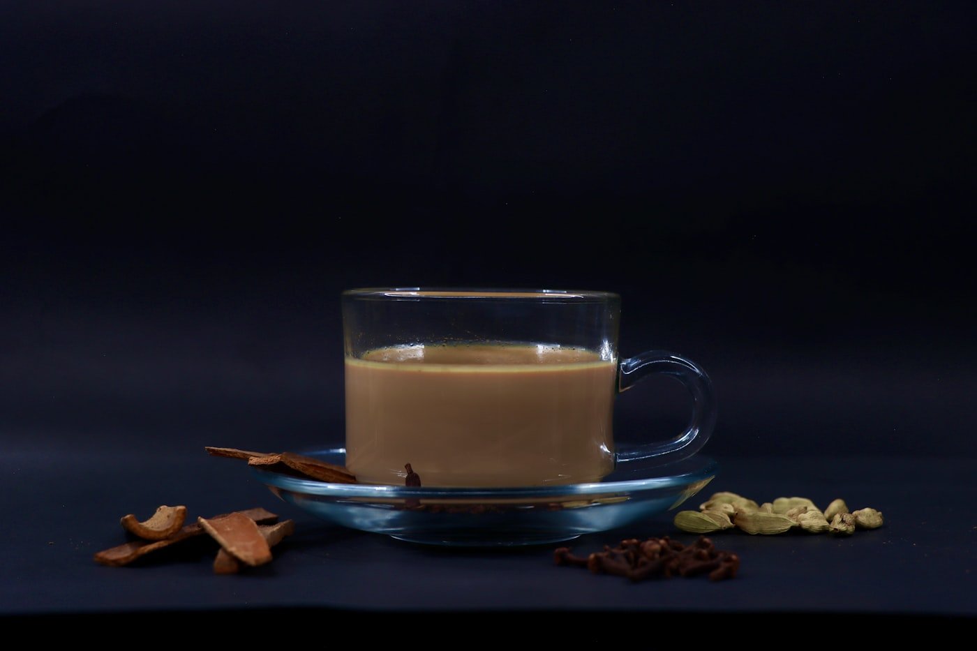 Glass of cardamom chai brewed with iliki and milk