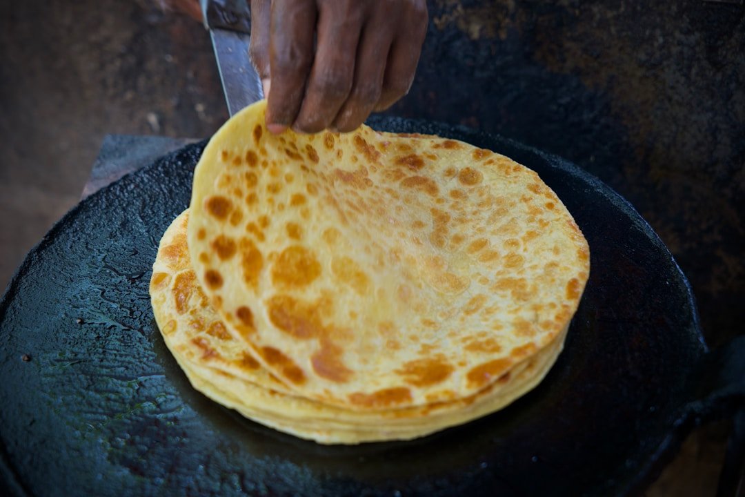 Chapati cooking on a hot griddle â€” a staple of Kenyan cuisine with Indian origins