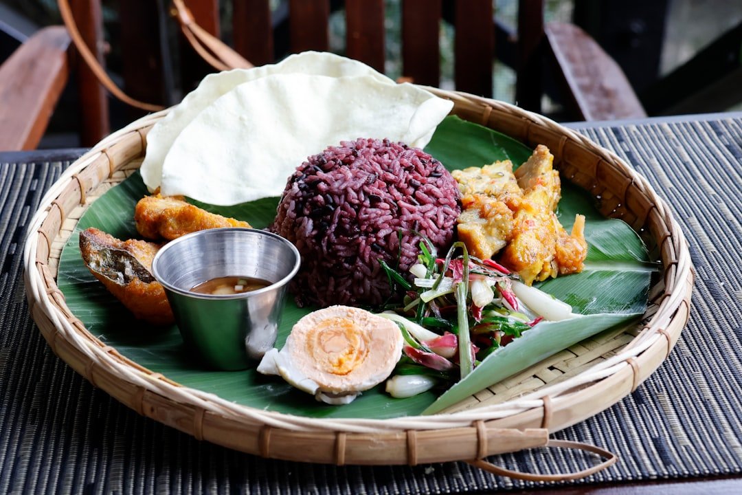 Kenyan fried tilapia served with ugali and kachumbari on a wooden board