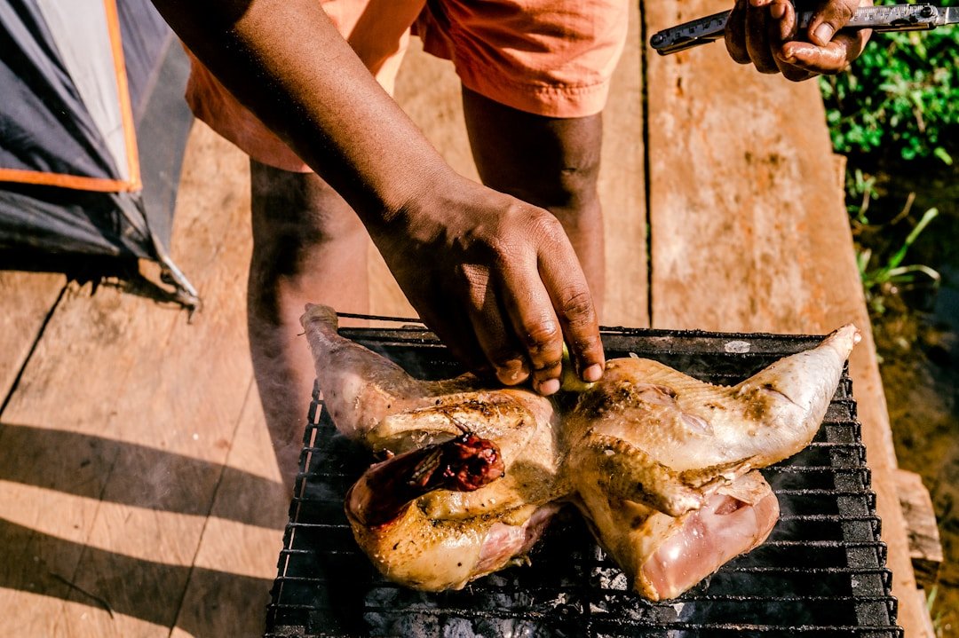 Street food vendor grilling meat at a Kenya outdoor market