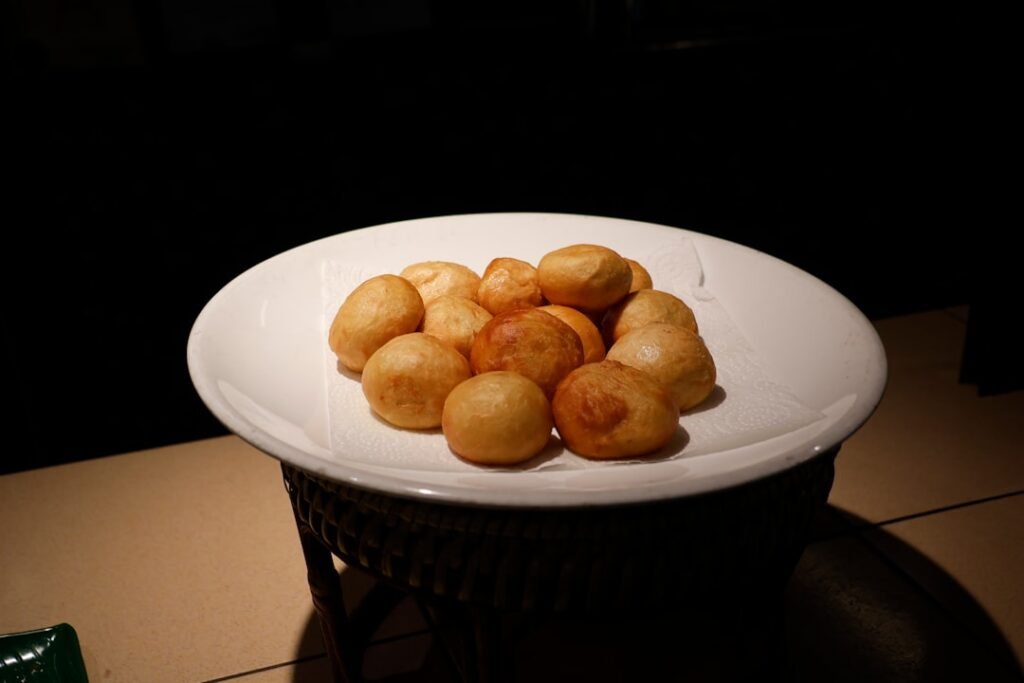 Golden brown mandazi on a plate - authentic Kenyan fried bread recipe