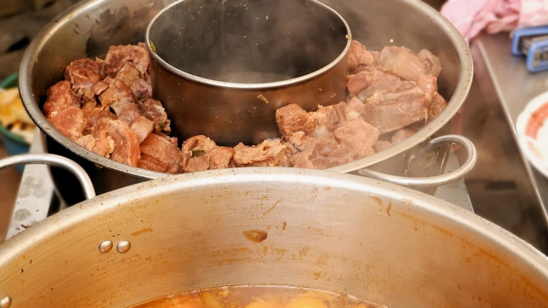 A large pot of simmering beef stew — the foundation of authentic mchuzi wa nyama