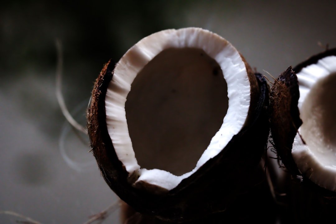 Fresh coconut halves showing white flesh for wali wa nazi kenyan coconut rice recipe