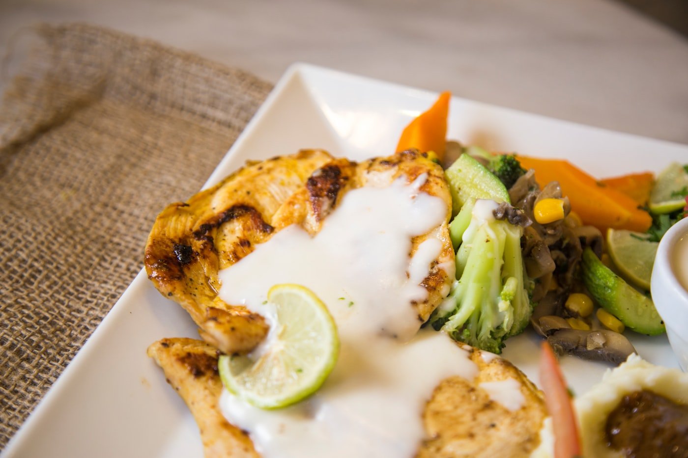 Grilled chicken thighs ready for kuku paka coconut sauce, a classic Kenyan coastal recipe