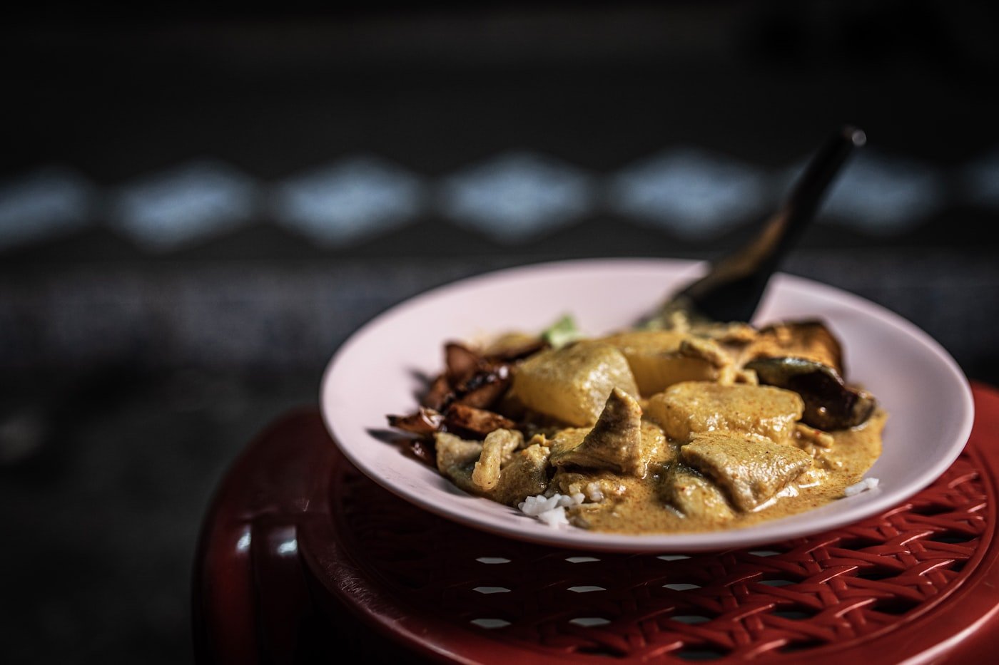 Bowl of kuku paka Swahili coconut chicken curry with golden sauce and fresh coriander