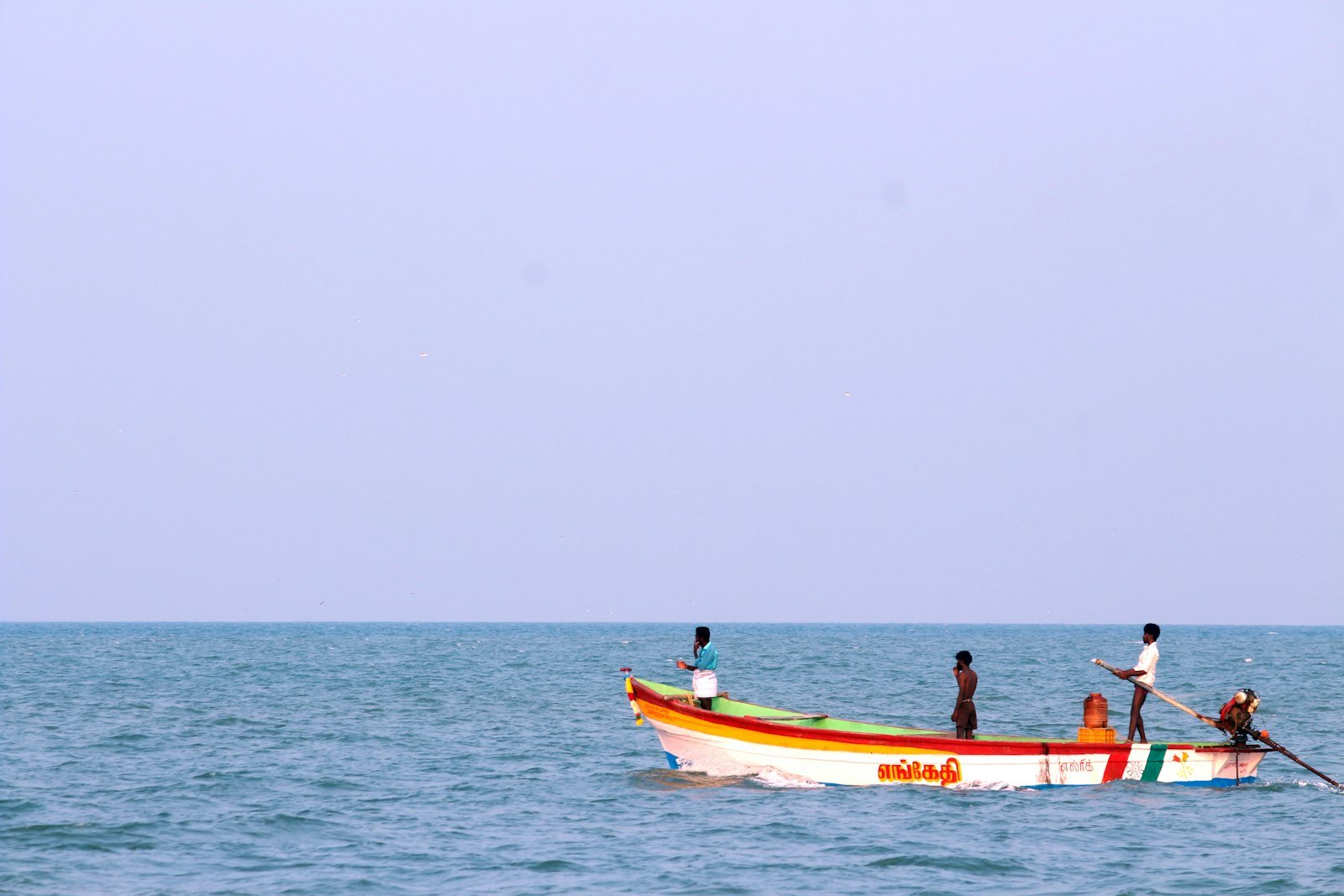 Wooden dhows resting on the Indian Ocean off Lamu Old Town at sunset