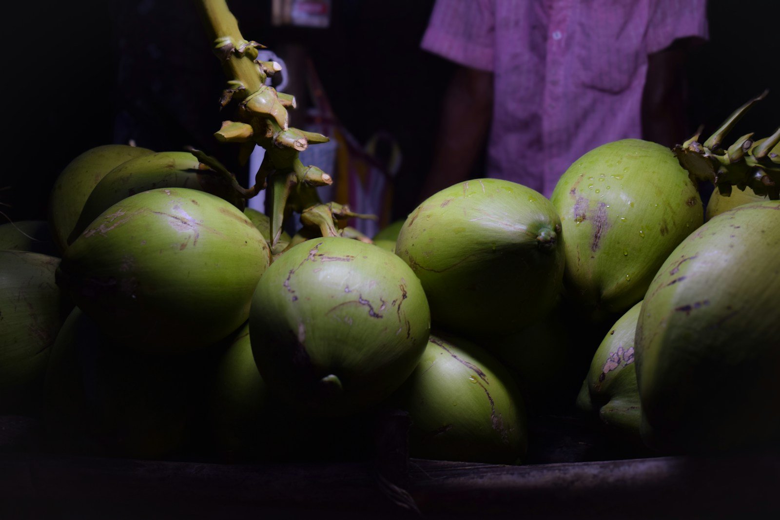 Pile of fresh green madafu coconuts at a Kenyan coastal market