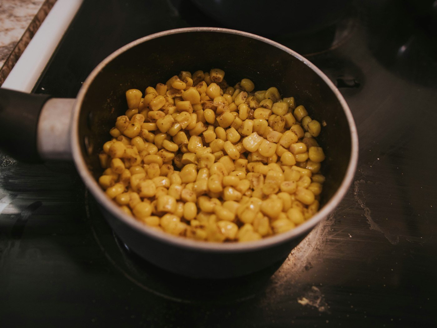 Fresh maize and beans simmering in a pot, the base of an authentic mukimo recipe