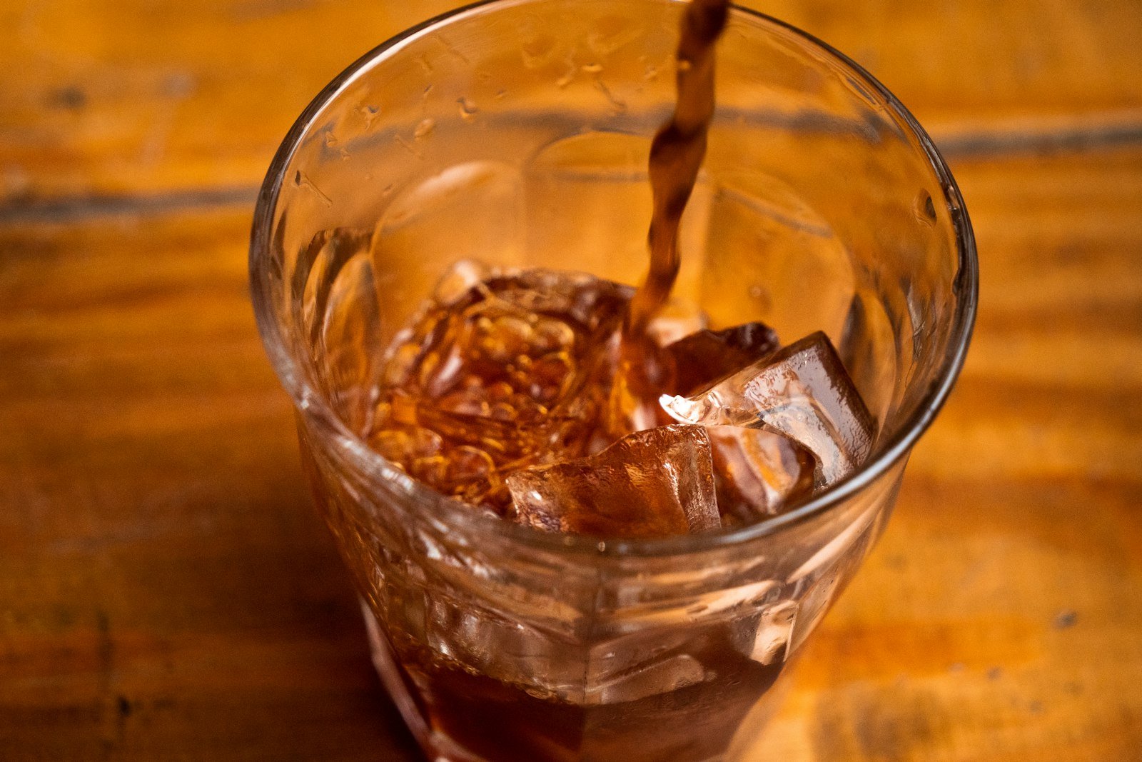 Stoney Tangawizi ginger soda poured over ice in a glass
